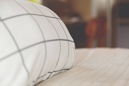 grey pillow on bedの写真素材