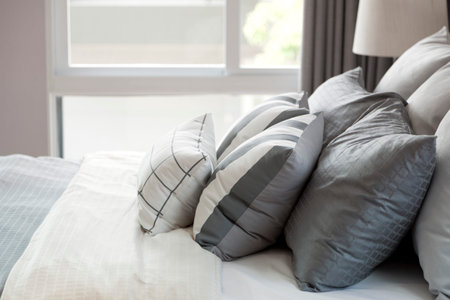 grey pillow on bed
