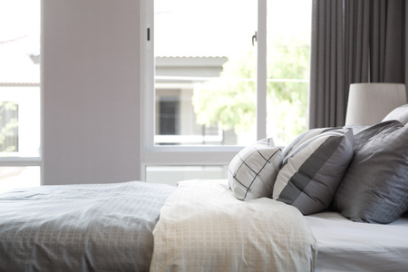 grey pillow on bedの写真素材