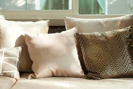 beige cushion on grey sofa