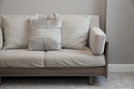 beige cushion on grey sofaの写真素材