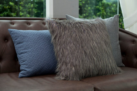 blue cushion on leather sofa
