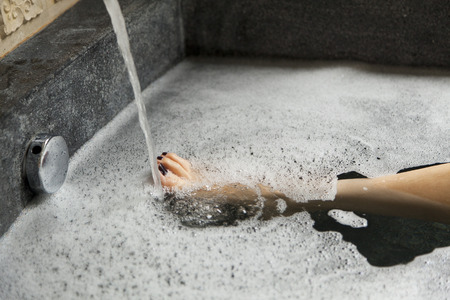close up of woman 's leg taking a shower in a bathtubの写真素材