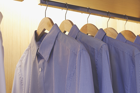 shirts hang in closetの写真素材