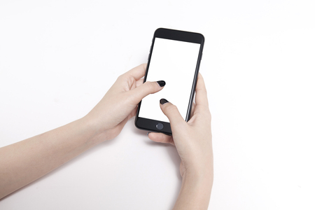Hand holding mobile smart phone with blank screen. Isolated on white.の写真素材