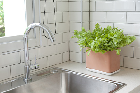 Modern kitchen with white worktop sink and big windowの写真素材