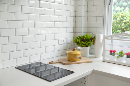 Modern kitchen with white worktop sink and big windowの写真素材