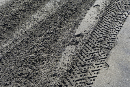 Tire tracks on seashore sand.の写真素材