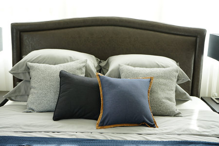 Modern classic style interior bedroom with pillows and black reading lamp on bedside table