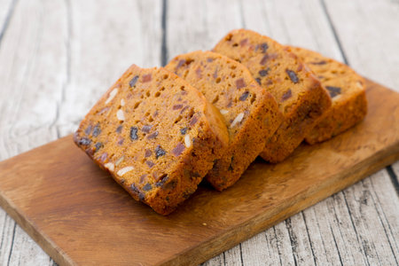 Homemade fruit cake on wood plate.