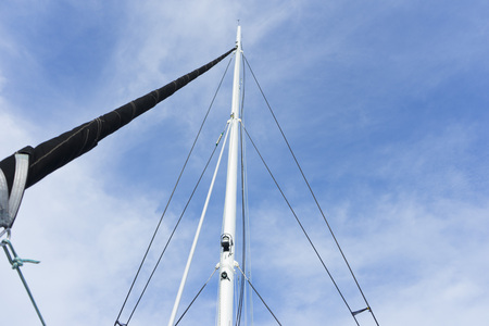 yacht mast with a white sailの写真素材