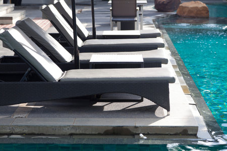 Cozy daybed with umbrellas by the pool