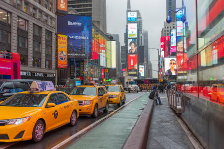 Crowded of tourist walking in Times Square with LED signs on building wall in New York City