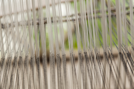A close up image of an old weaving Loom and thread of yarn.の写真素材