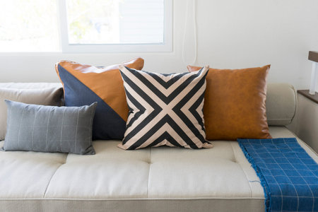 luxury brown leather cushion on sofa in modern living room.