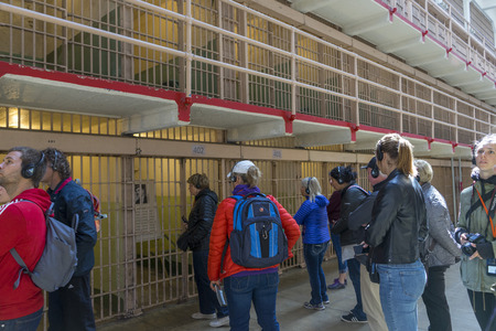 Tourists visiting Alcatraz prison and the main corridor with ordinary single cells on ground level. San Francisco historical landmarkのeditorial素材