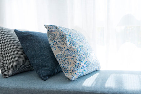 View of comfortable modern corner couch sofa with many pillows outside on loft balcony