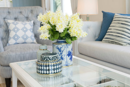 white flower in ceramic vase on table in contemporary living room