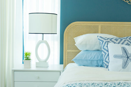 Vintage master bedroom with blue wall and white table lamp.