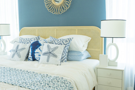 Vintage master bedroom with blue wall and white table lamp.の写真素材