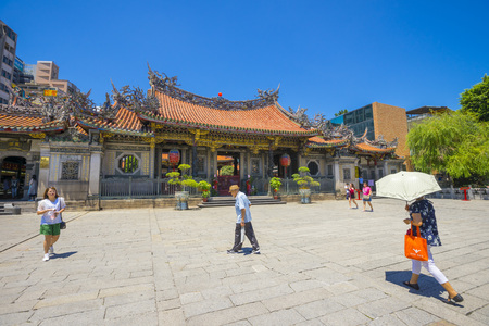 People walking in front of the gate of Longshan Temple in Taipei, Taiwanのeditorial素材