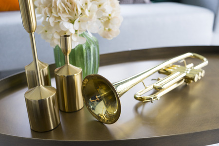 colorful and stylish living room with flower vase and gold trumpet on table.の写真素材