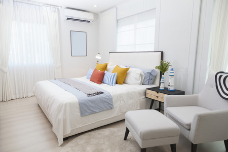 Modern home interior with bedroom setting including bedside table ,white lamp and plant pot on it.のeditorial素材