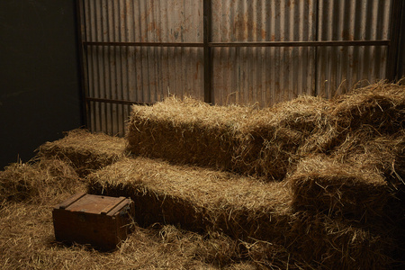 hay stacks in barn house with zinc wallの写真素材