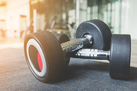 dumbbell weights on wood floor at fitness gymの写真素材