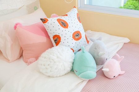 Cute teddy bears and dolls on bed for little girl