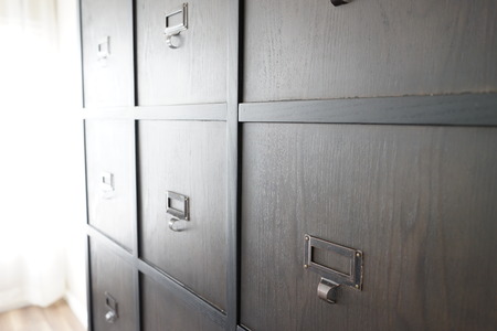 metal handle on the wooden door of the cabinet.の写真素材