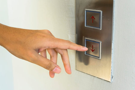 woman pressing elevator button.