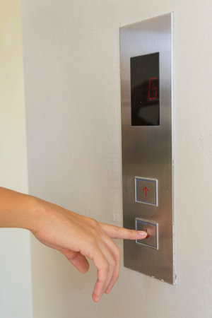 woman pressing elevator button.