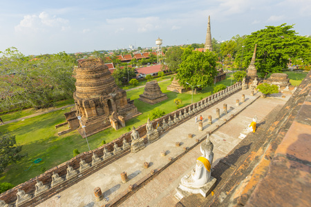 Row of Buddha statues in Wat Yai Chaimongkol in Ayutthaya ,Thailand.のeditorial素材