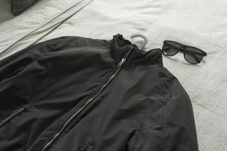 Black jacket on bed,man cloth prepare to dress.の写真素材