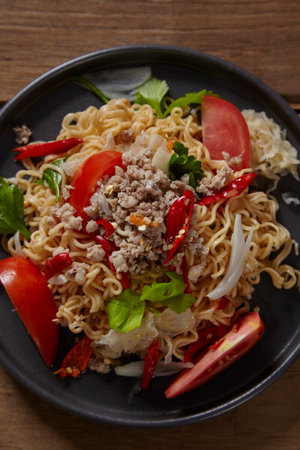 Spicy mama salad with pork on wood table,Spicy noodle.
