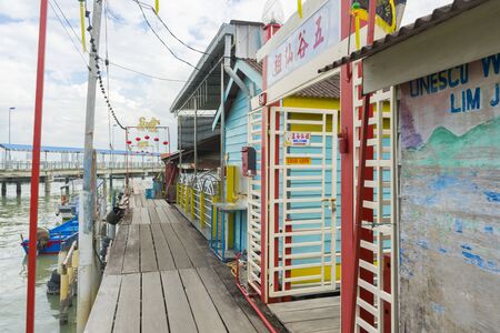 Unidentified tourist walking on wood walkway at Chew Jetty in Penang, Malaysiaの写真素材