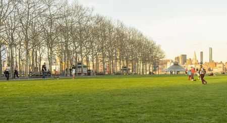 People walking in Pier A Park at twilight time in Hoboken, NJ, USAの写真素材