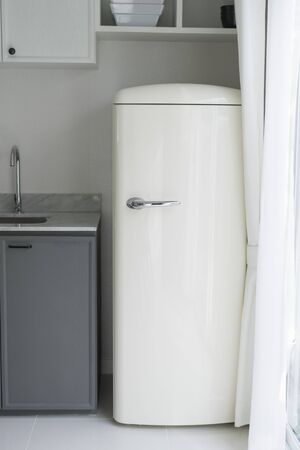 Modern white kitchen, gas stove with electric oven, fridge, clean designの写真素材