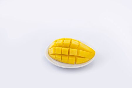 Slices of yellow ripe mango on whiteの写真素材