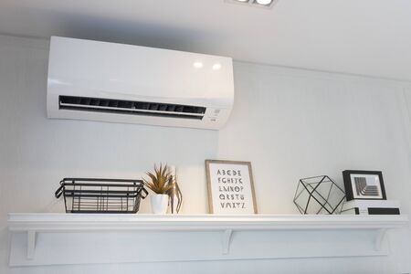 Air conditioner split type embed on wall of living room.の写真素材
