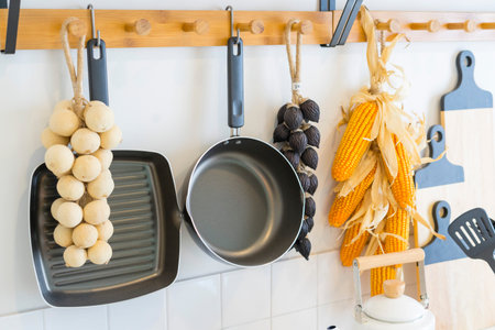 Arrangement of dry food products, spices and ceramics kitchen equipment hanging on country shelves...