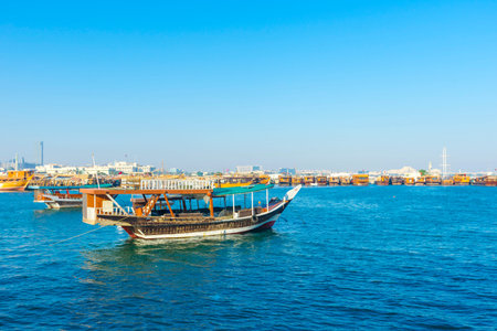 Traditional boats called Dhows are anchored in the port near Museum of Islamic Art Park,Doha, Qatar.