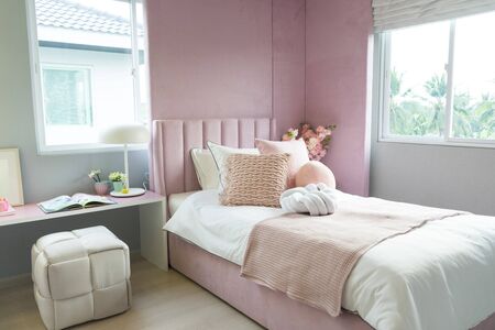 Children bedroom with pink pillows. Bed for baby or toddler girl at home.の写真素材
