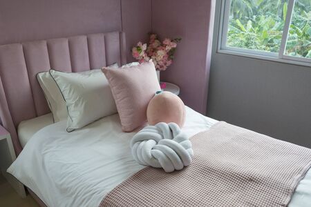 Children bedroom with pink pillows. Bed for baby or toddler girl at home.の写真素材