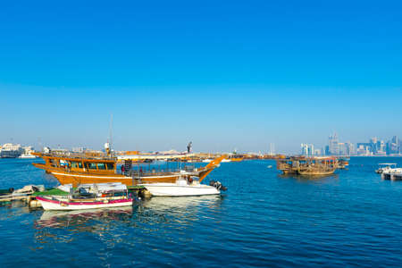 Traditional boats called Dhows are anchored in the port near Museum of Islamic Art Park,Doha, Qatar.のeditorial素材