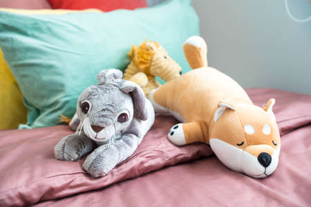 Modern bedroom with rabbit dolls on bedの写真素材