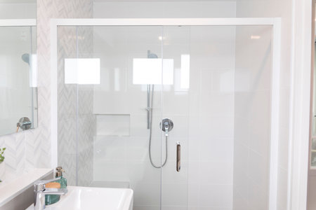 Shower room with chrome tap, transparent glass doors and a shelf.