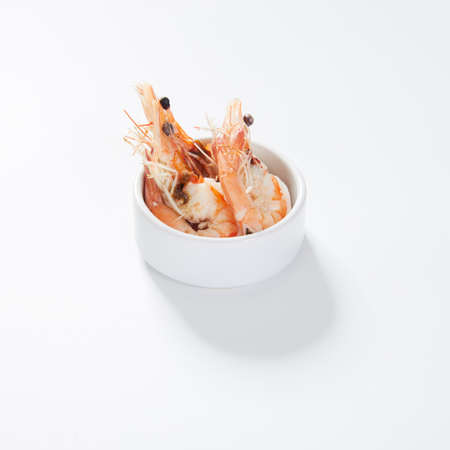 boiled peeled shrimp prawns in a bowl on white background.の写真素材