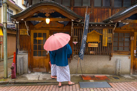 Unidentified couple walking on the street of Historic ryokan and hot spring resorts in Shibu Onsen in Nagano City, Japanのeditorial素材